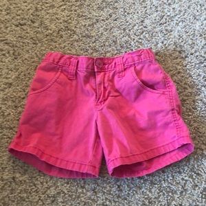 Hot pink shorts.